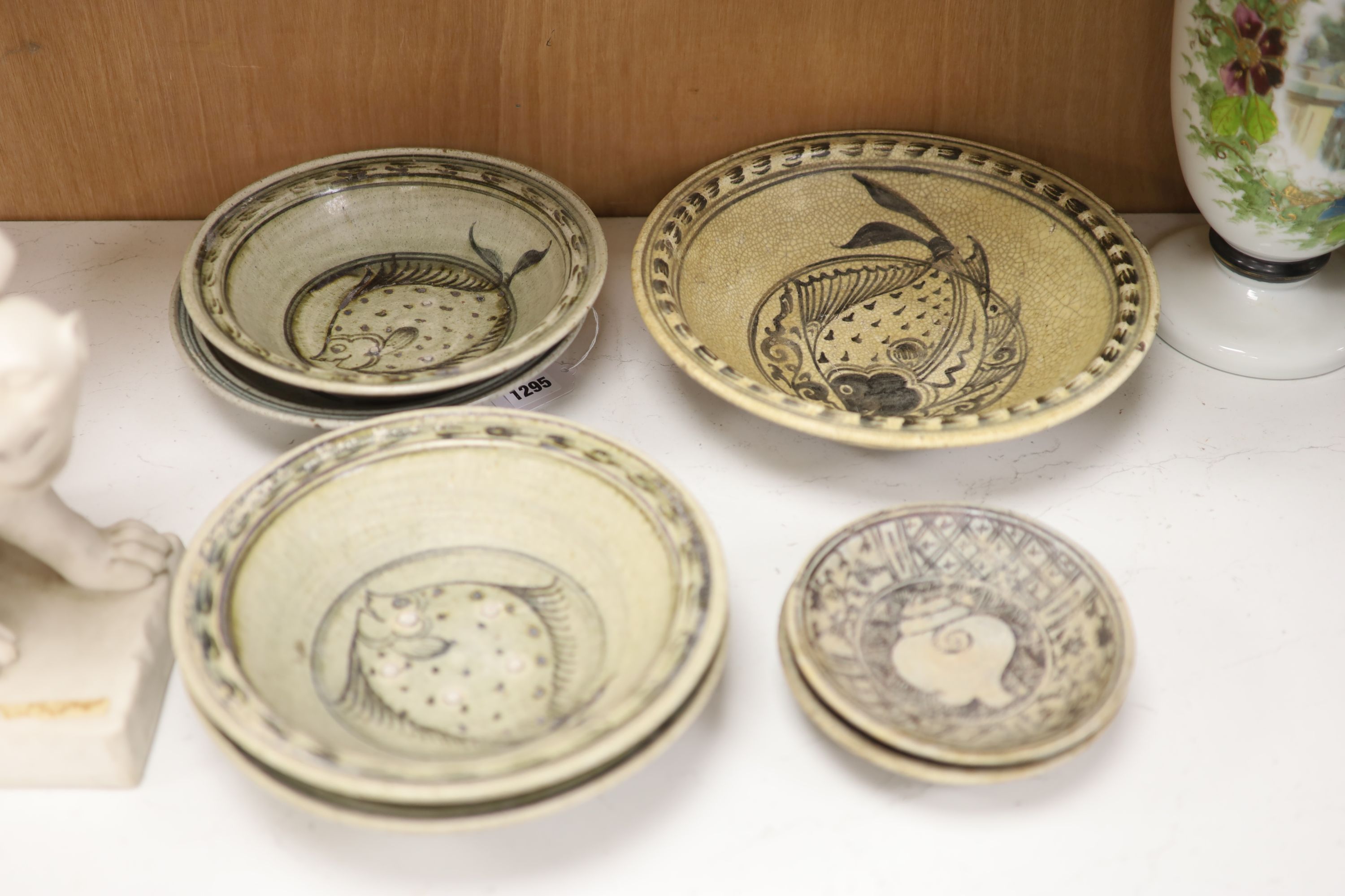 A group of Sukhothai style pottery dishes, largest diameter 29cm (7)